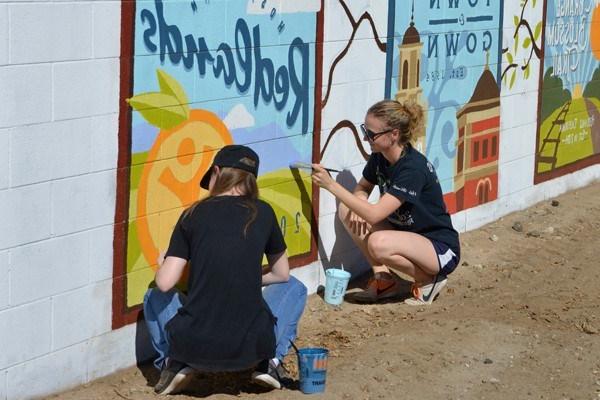 Students painting a mural